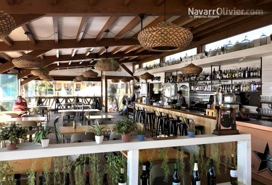 Vista interior de restaurante de madera con cerramiento en cortina de cristal