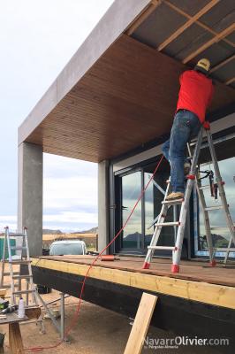 Montaje de friso de madera en porche de casa sostenible modular