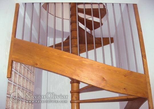Escalera de caracol con barandilla de acero inoxidable.