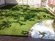 Jardin con césped artificial Bermuda